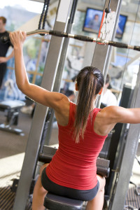 Woman Weight Training At Gym