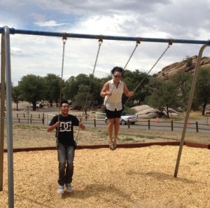 Kiki and AJ on the park swings